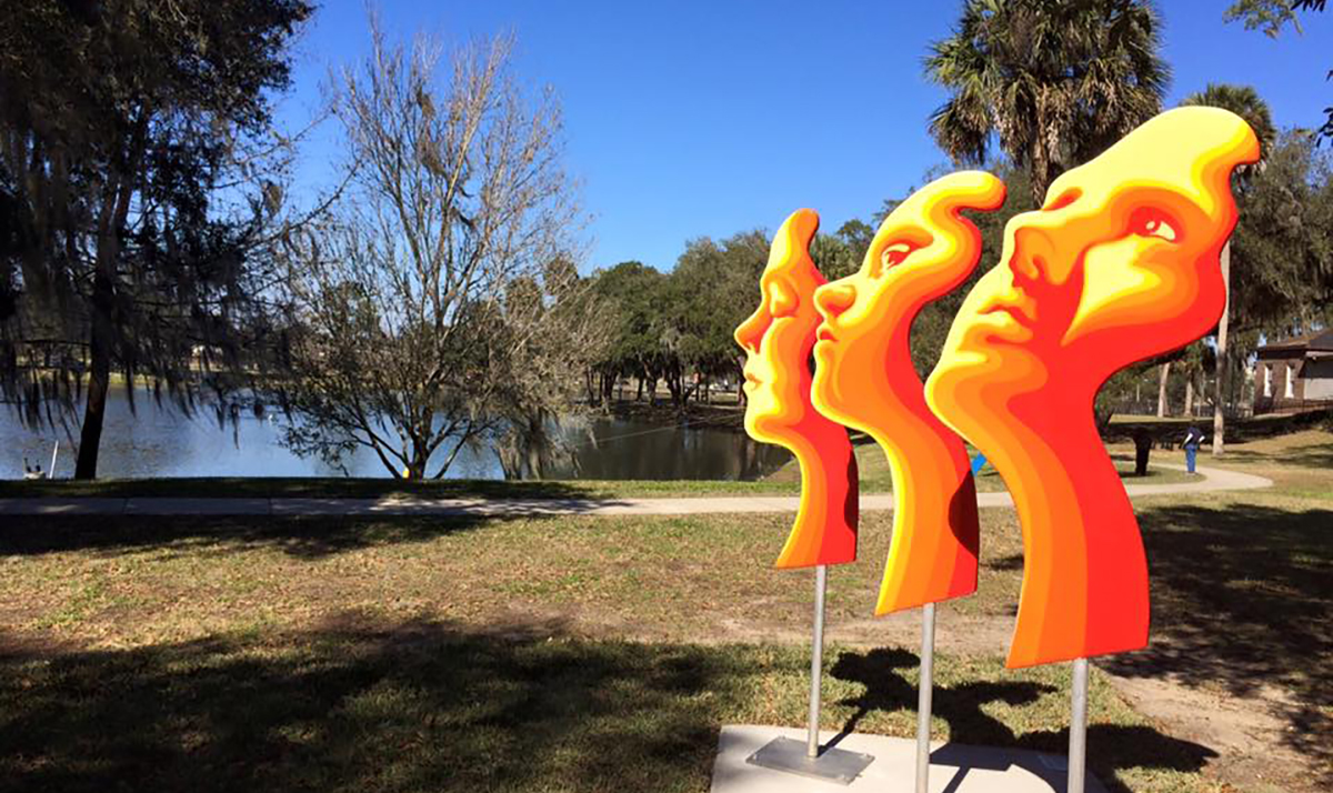Sculpture with three faces at Ocala campus.