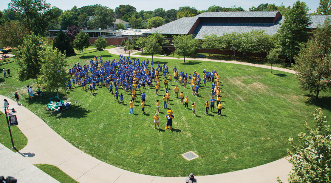 Webster University Campus with group of students outside with Gorlok