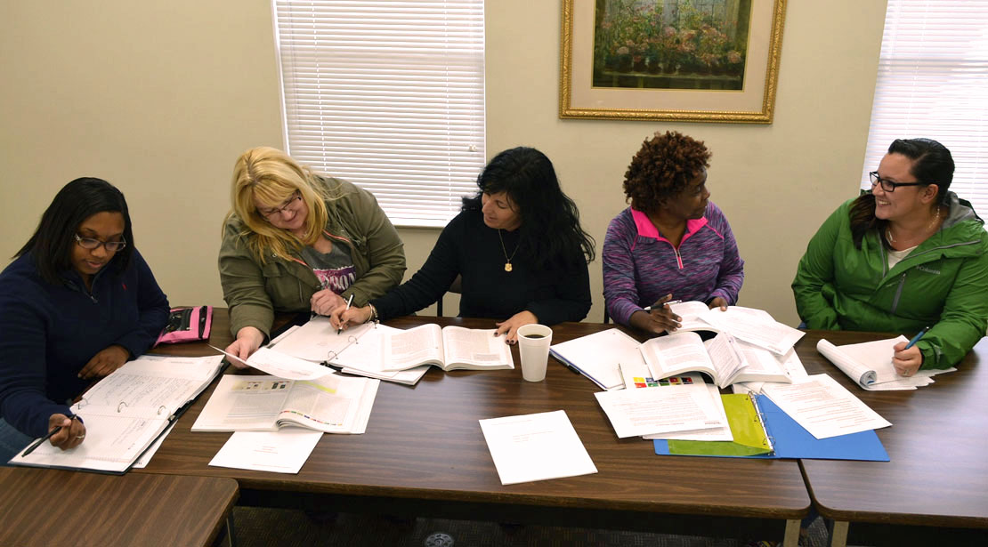 Five Webster University students studying together.