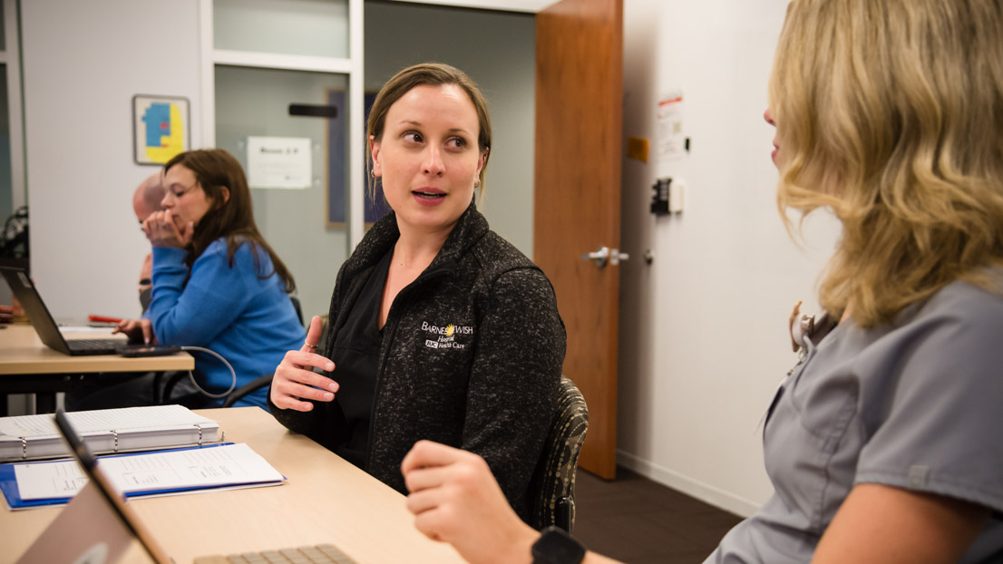 Health care workers studying Business Fundamentals in a Webster classroom