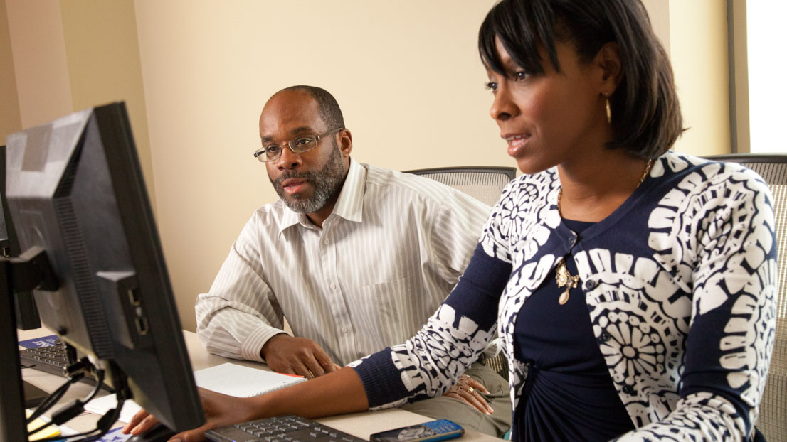 Two adult learners at a computer