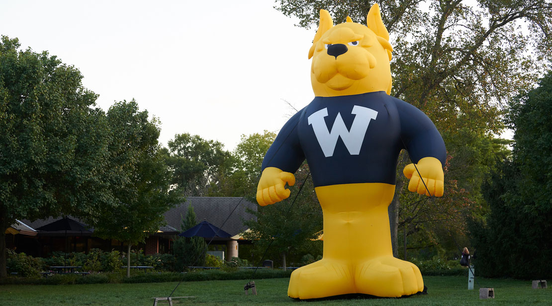 A very large inflatable Gorlok mascot is anchored in a green field.