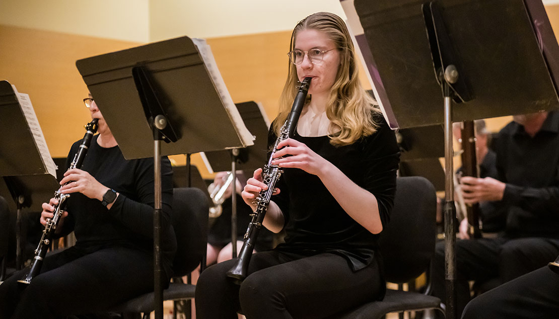A student playing the clarinet during a Webster University Wind Ensemble concert.