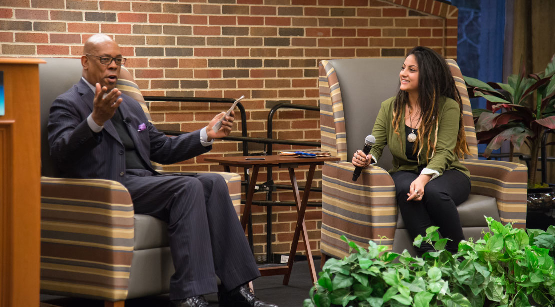 Art Holliday seated on stage with the interviewer