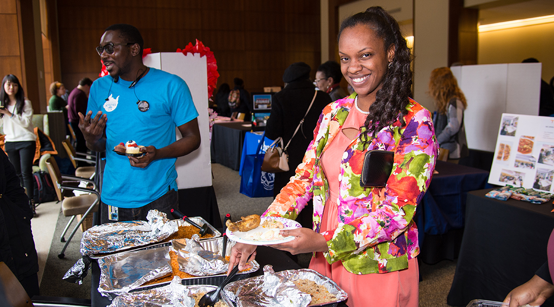 woman holding a plate dishing food from the buffet