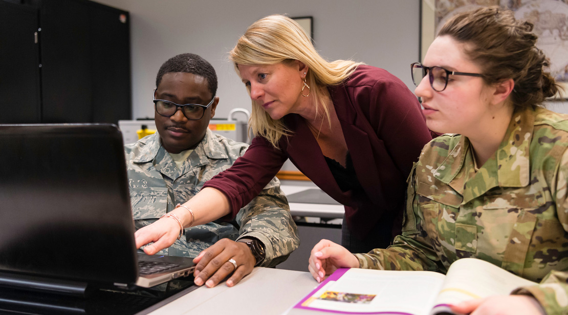 Webster professor assists student on computer