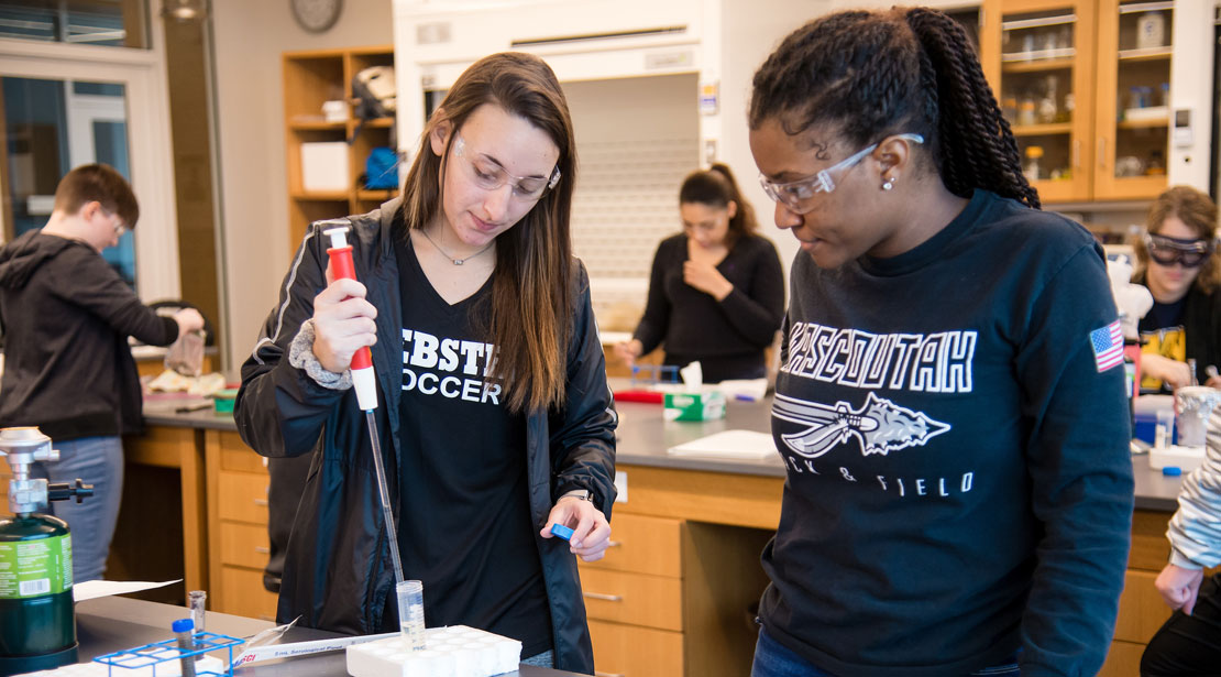 Two Webster students conducting experiment.