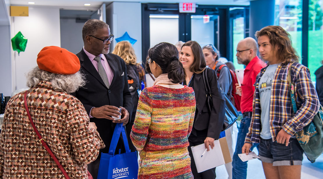 One of the conference speakers talking with attendees