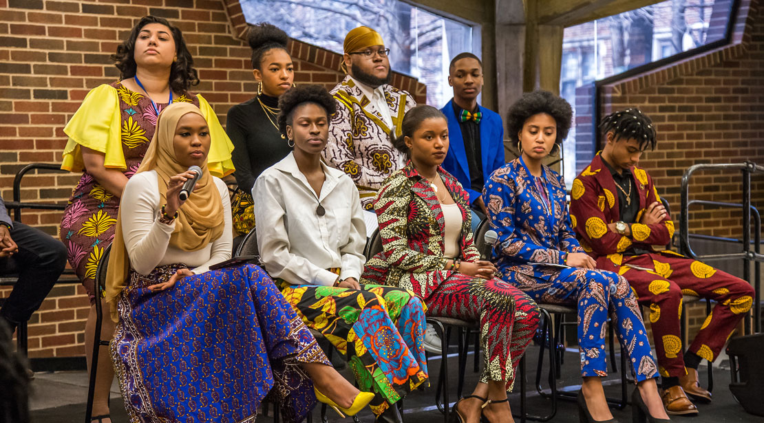 Group of Webster students sit on stage to discuss Africana Studies