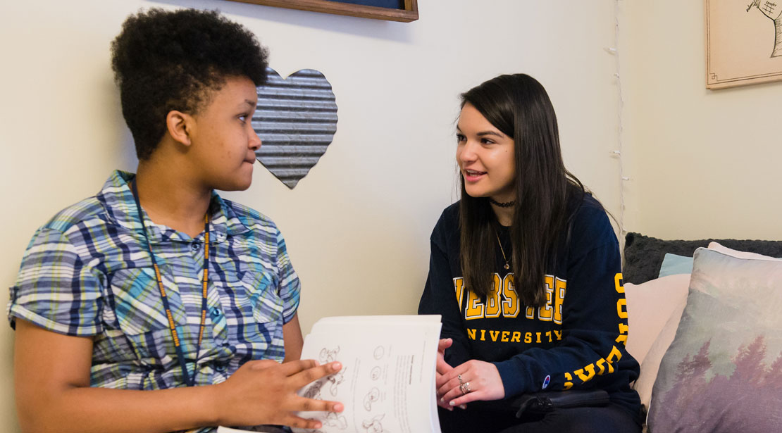 Two female students talking and studying