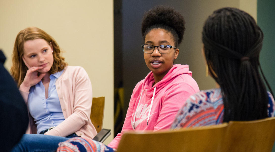 Student talking while two others listen