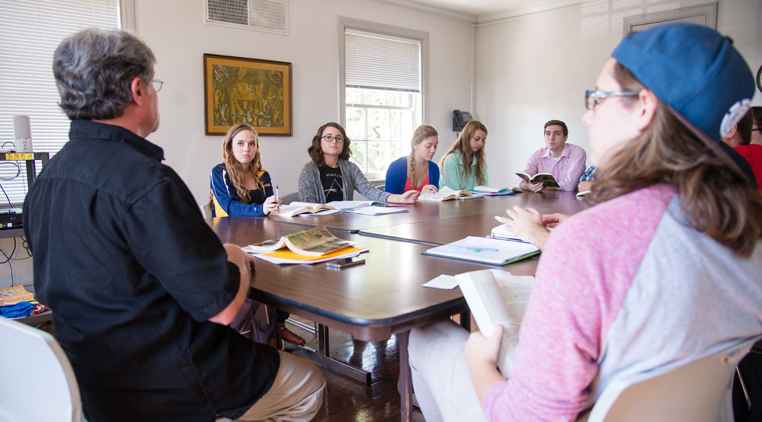 Students around a table in a classroom