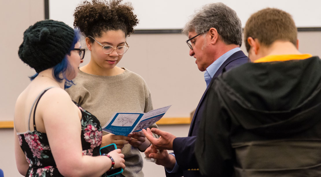 Students and a teacher discussing materials