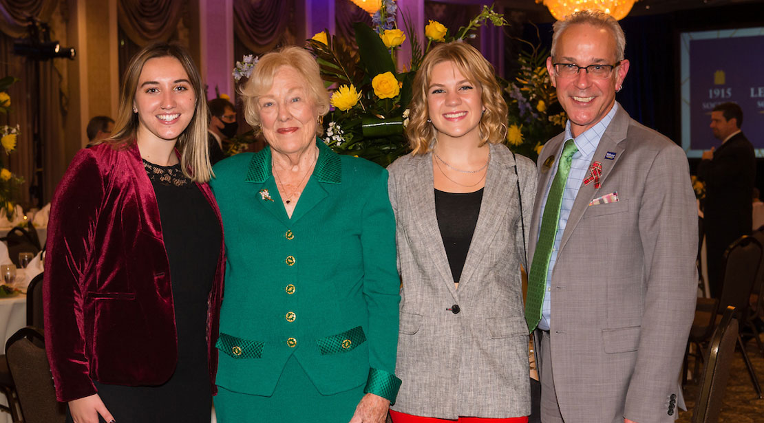 Visionary Award recipient Mary Alice Dwyer-Dobbin stands with family and Dean Eric Rothenbuhler.