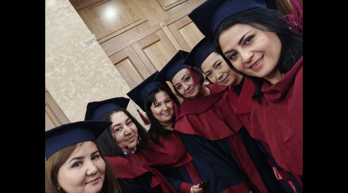 Six graduates of Webster Tashkent's MA in Teaching English to Speakers of Other Languages program in cap and gown
