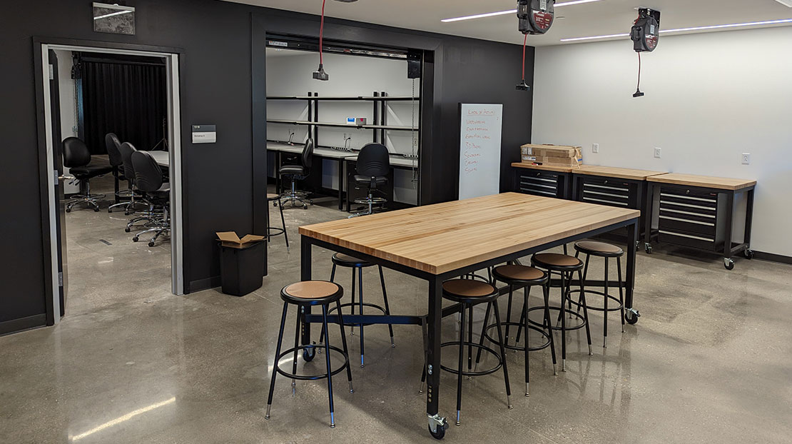 fabrication room with wood table and stools