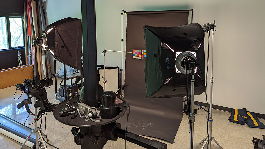 photography studio with box lights, backdrop and color card in front of camera equipment