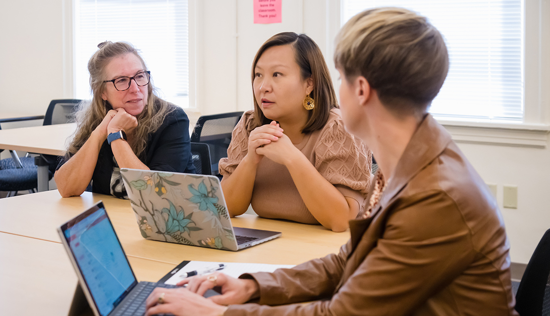 Two students and the professor in a teaching cohort in School of Education