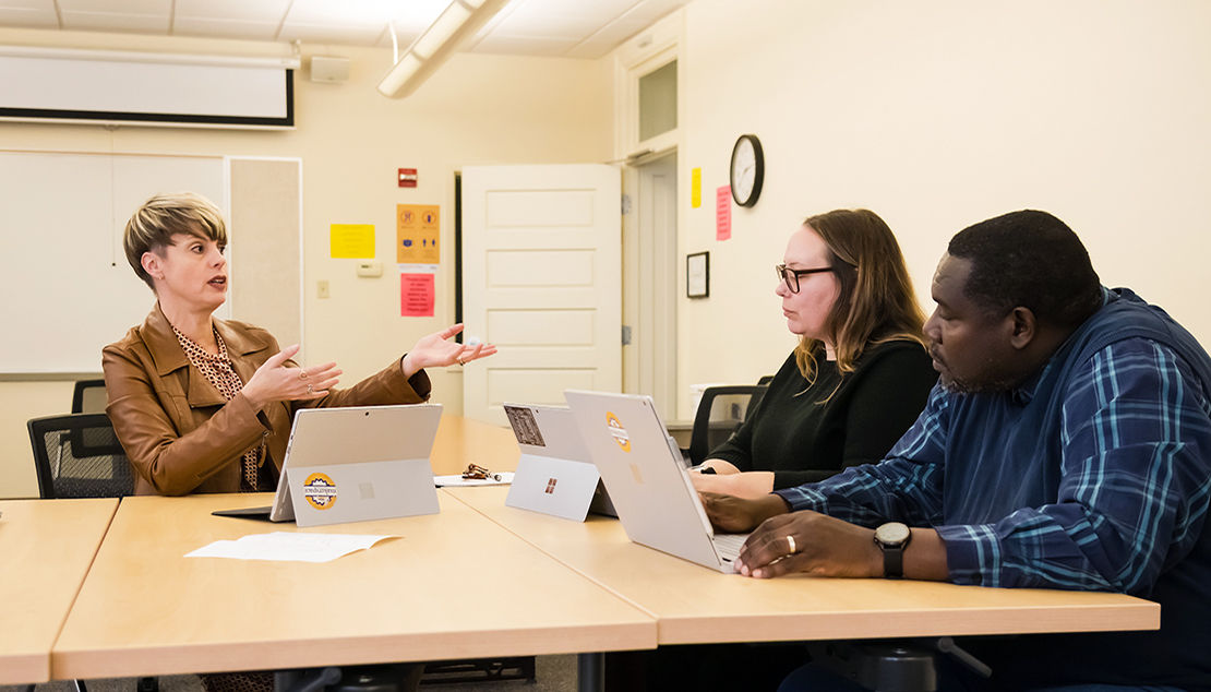 Two students and the professor in a teaching cohort in School of Education