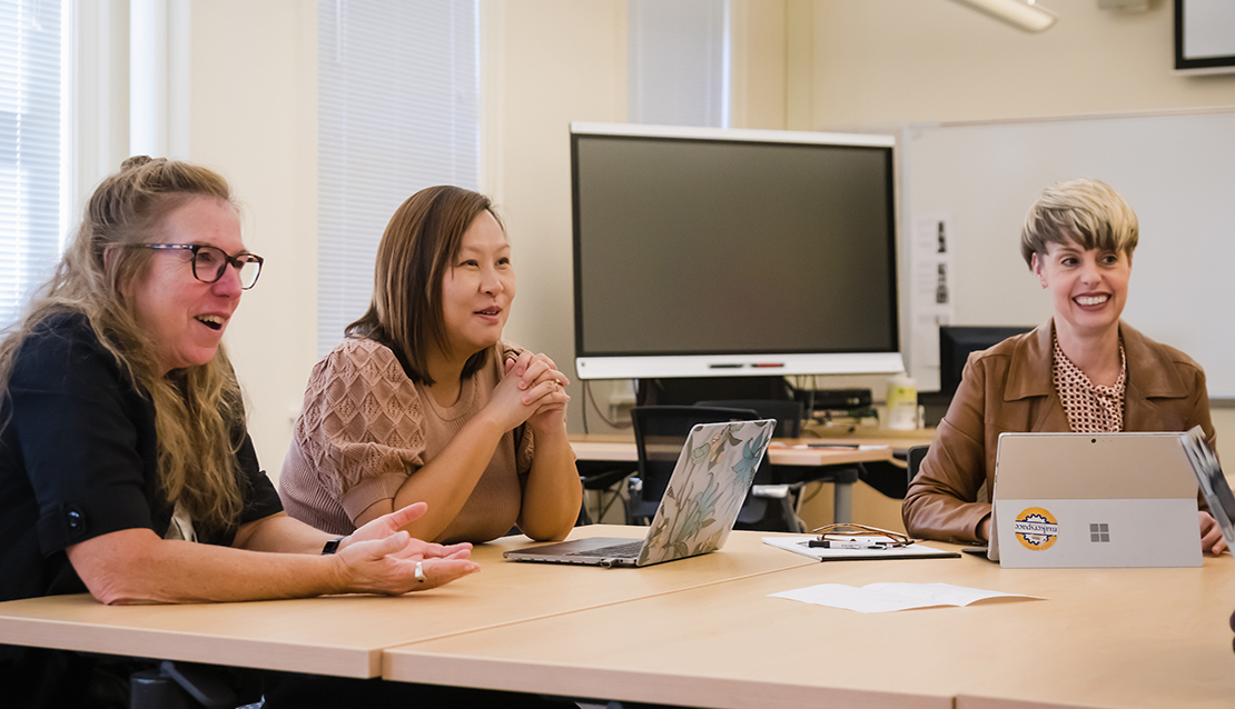 Two students and the professor in a teaching cohort in School of Education