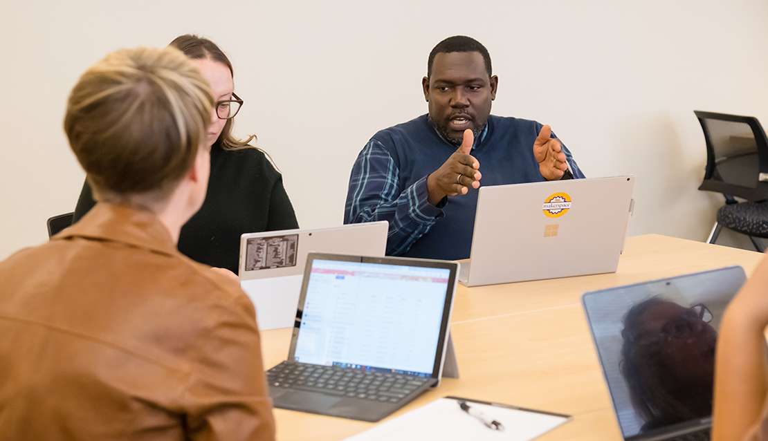 Two students and the professor in a teaching cohort in School of Education