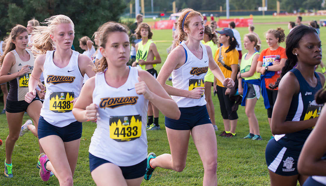 diverse group of women running cross country 