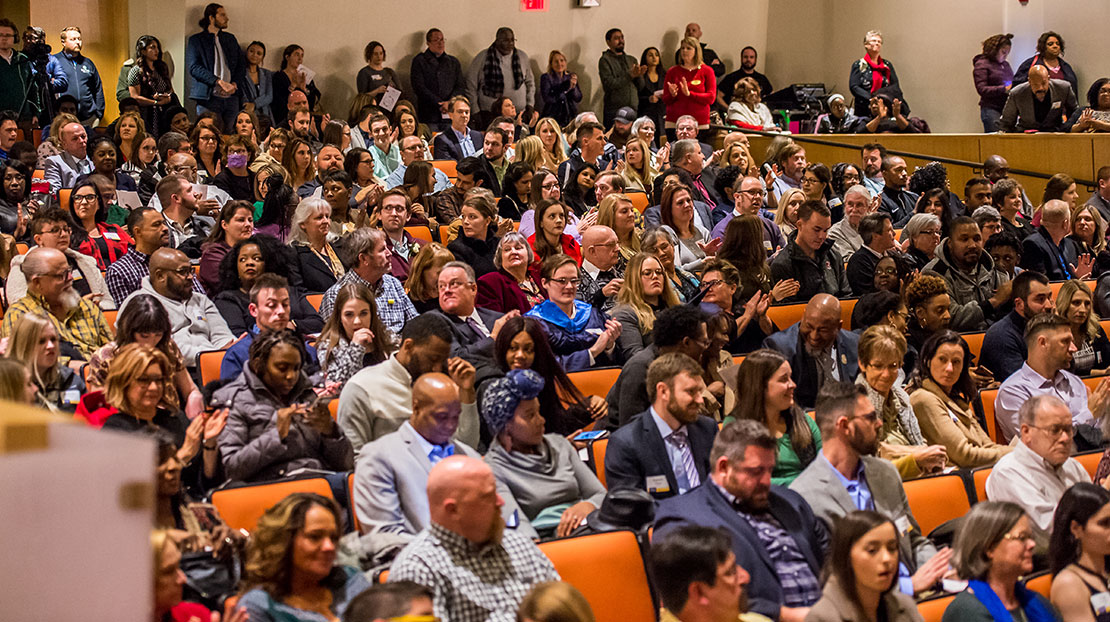 Large audience sitting in seats at December Toast event