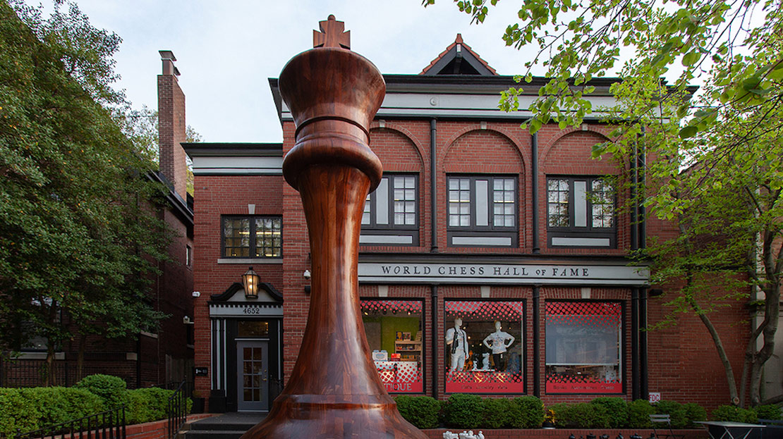 A front view of the World Chess Hall of Fame and a giant chess piece sculpture.