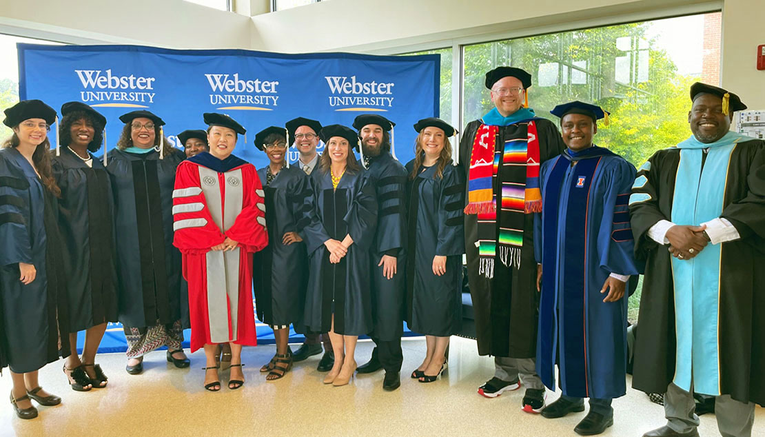 graduates of the edd program pose with faculty members after commencement.