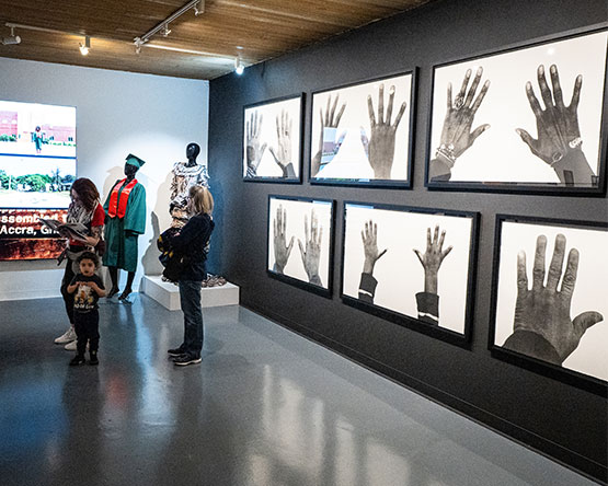 Wall with several black and white photos of black hands