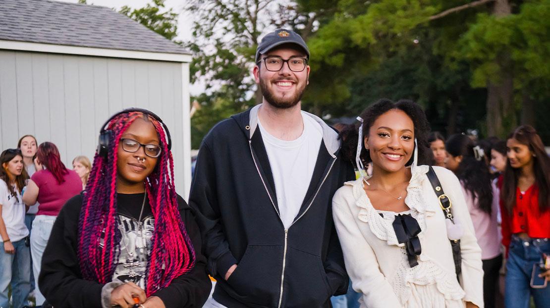 A small group of students pose for a photo.