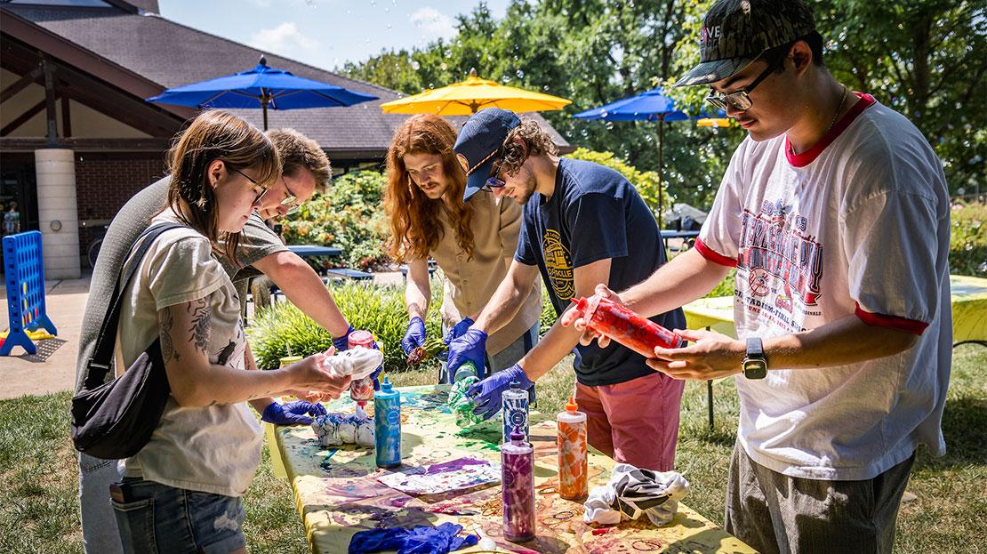 A group of students making tie-dye garments.