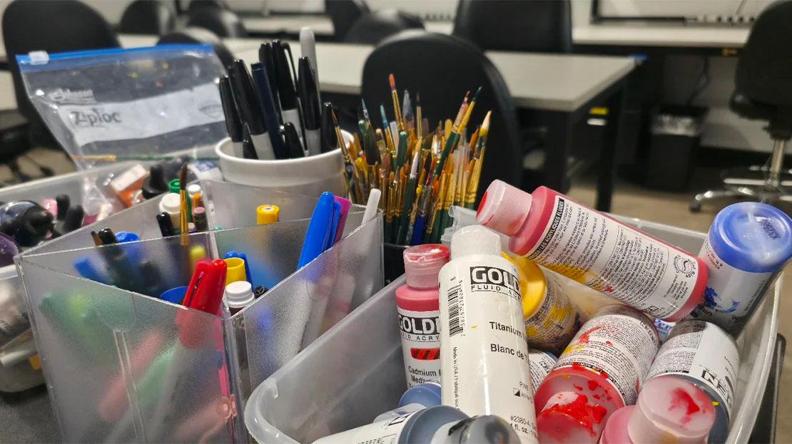 A collection of professional quality paints, markers, brushes, pens and other implements for student use in the workshop.
