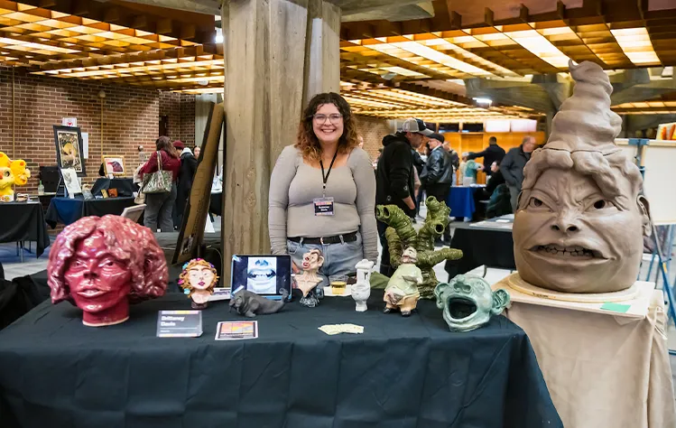 Webster student presenting her original ceramic creations at the 2024 DADAH Showcase.