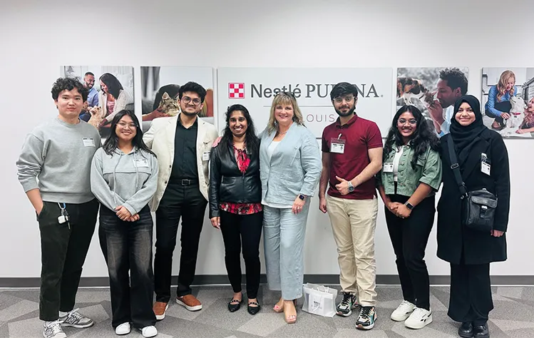 Webster students and faculty pose at Nestlé Purina during a tech site visit.
