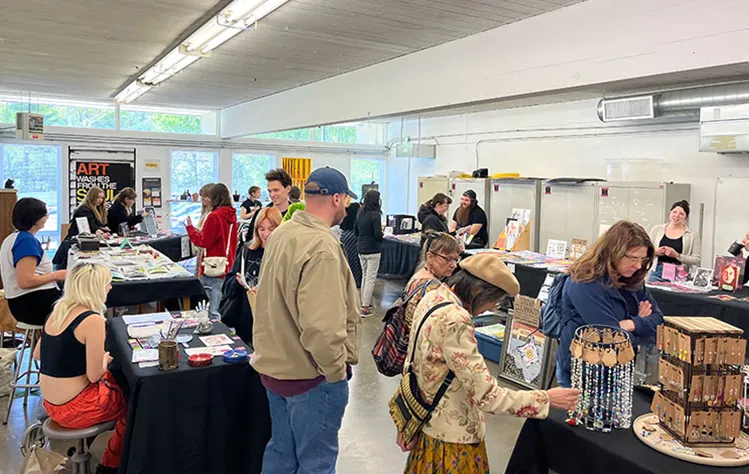 Visitors browse student artwork and handmade items at the 2024 DADAH Marketing in the Visual Arts Studio