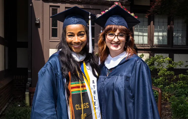 Two graduates at Commencement
