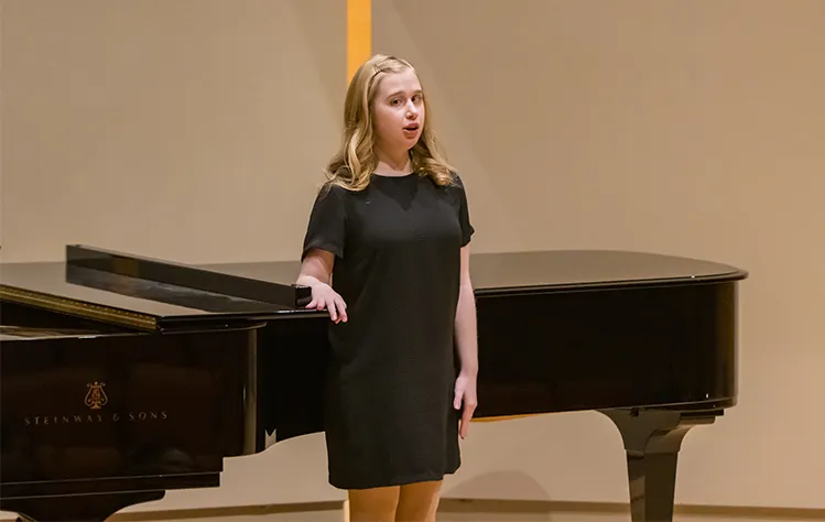Holly Connor sings on the Community Music School stage.