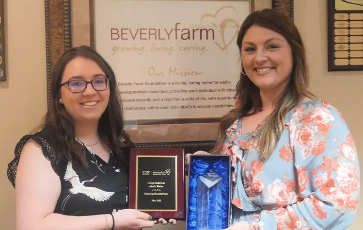 Alexis Weller and Taylor Justice holding awards received in 2023