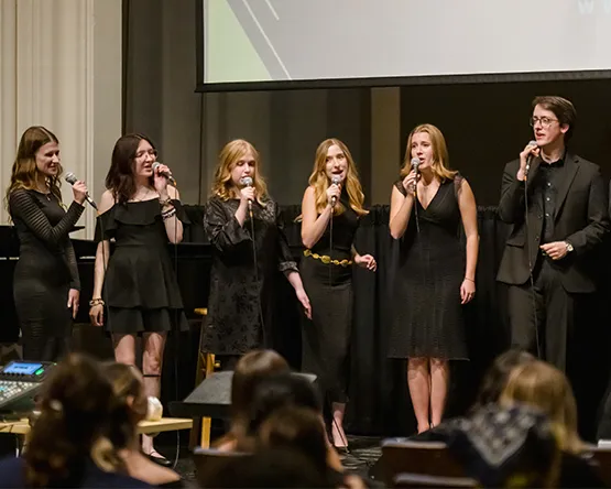 Student vocalists perform in a jazz ensemble.
