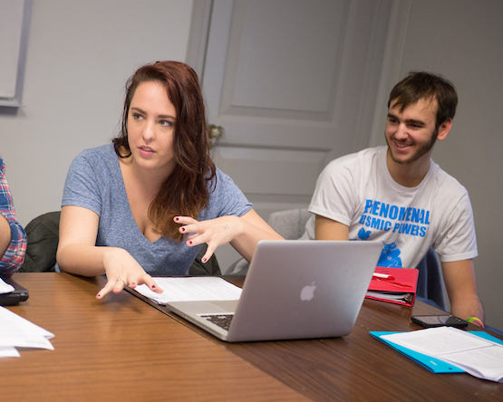 Two students discussing ideas in class.