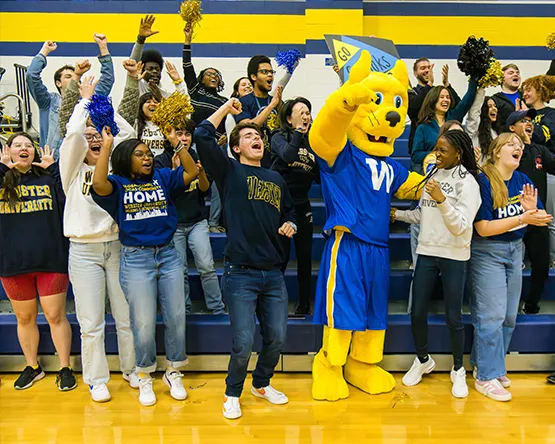 Gorlok mascot cheers with student