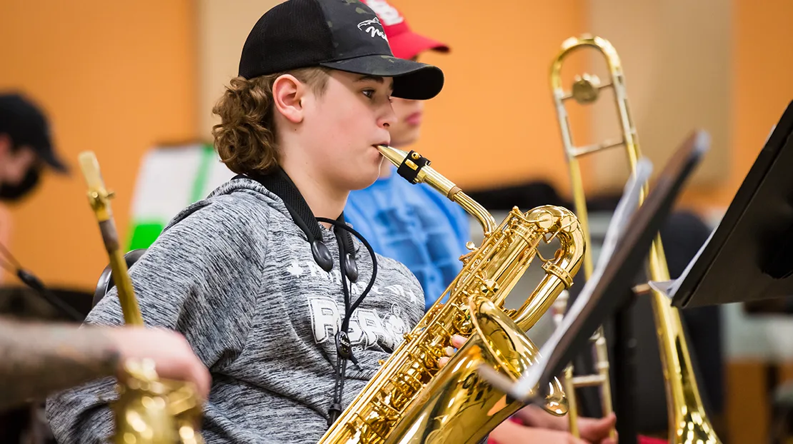 middle school boy playing bari-saxophone